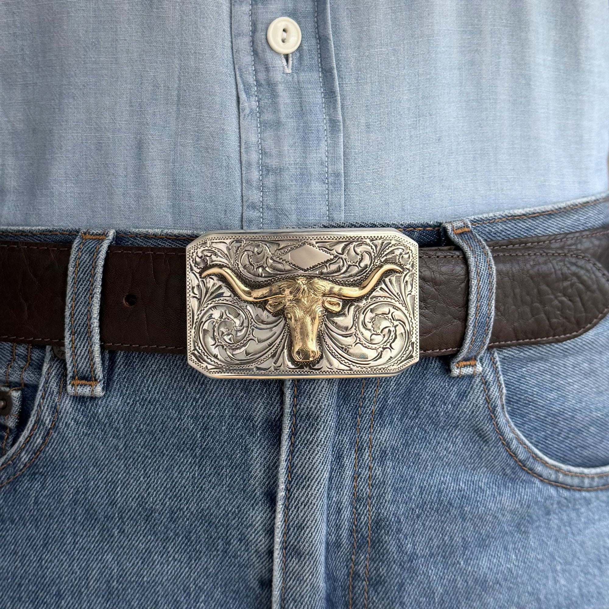 rectangular engraved Bohlin buckle with a gold longhorn on brown belt