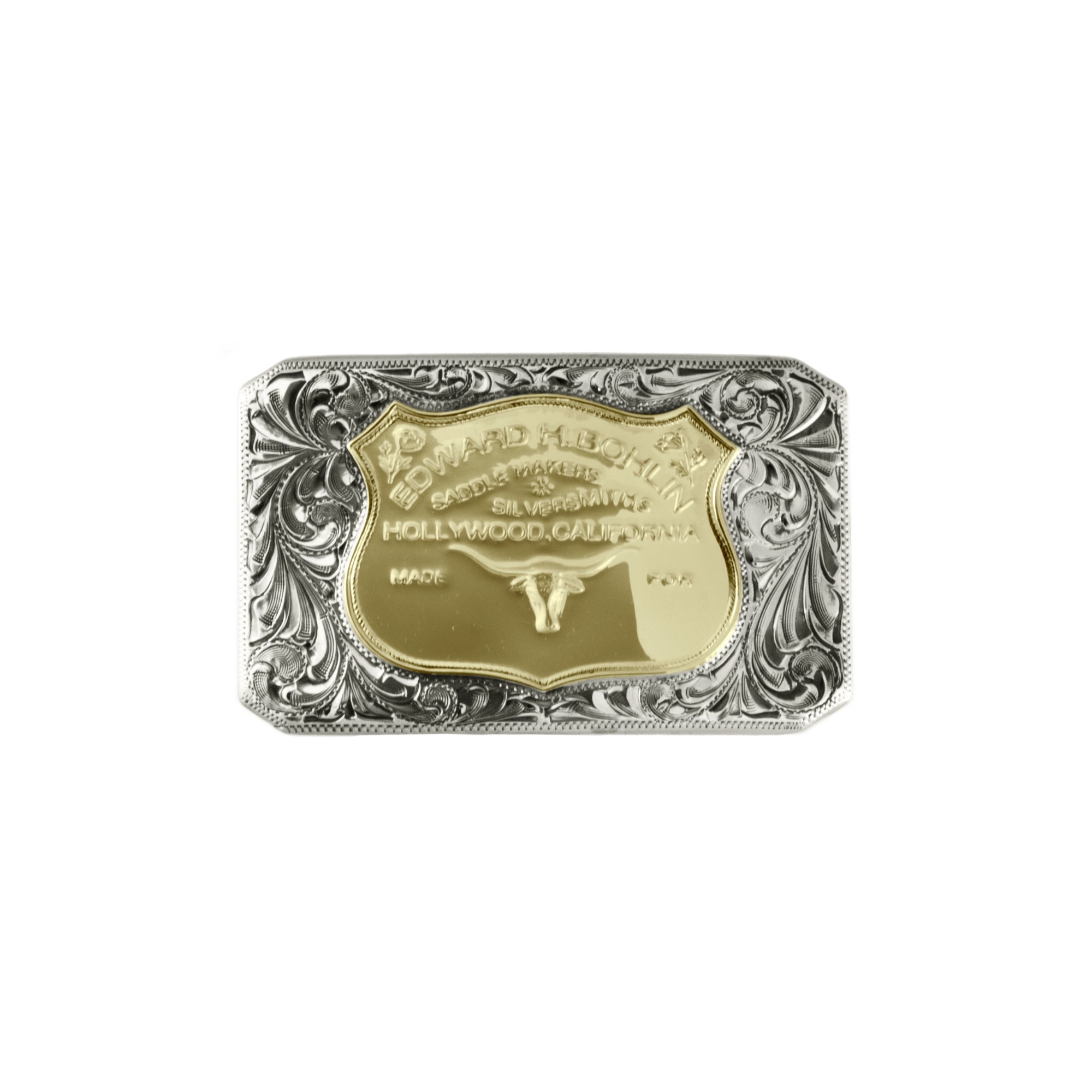 A rectangular silver buckle with ornate floral engraving and a central 14kt gold shield emblem featuring a longhorn symbol and the text 'Hollywood, California' and 'Made in USA'.