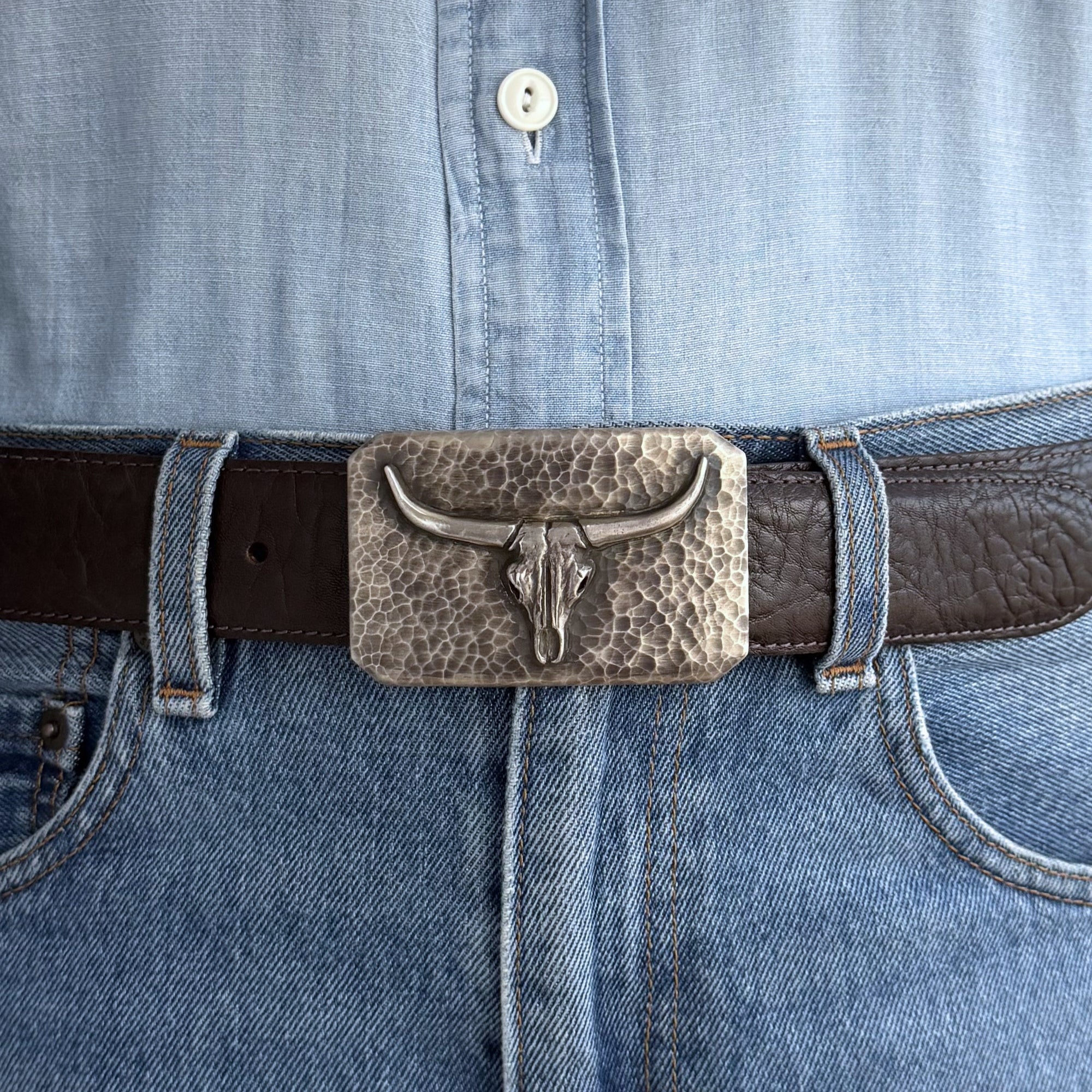 Rectangle hammered skull on belt.