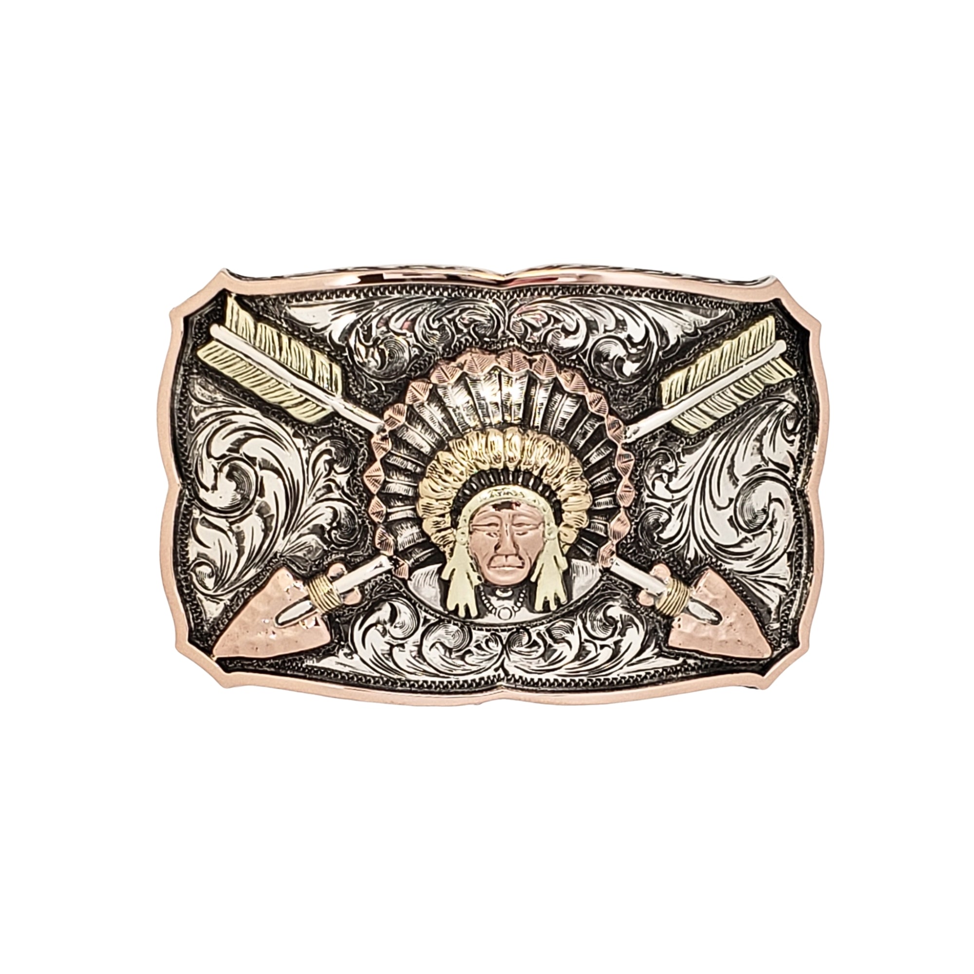 A rectangular western-style belt buckle featuring a Native American face in the center, surrounded by a feathered headdress, crossed arrows, and ornate engraved scrollwork. The buckle has a rose gold-toned border and face, with silver-toned engraved details and dark recessed accents.