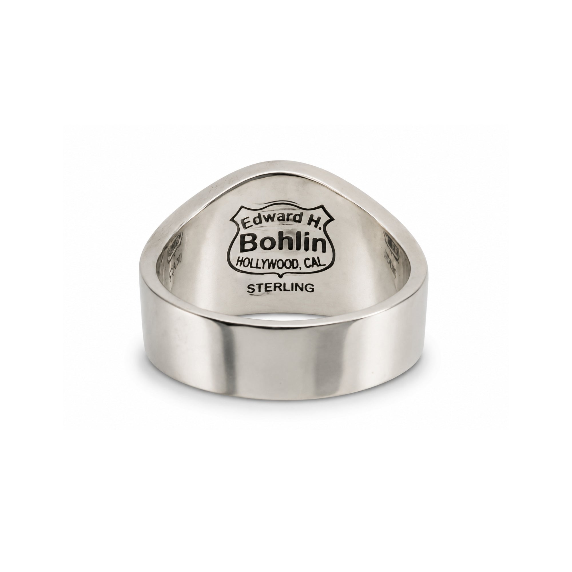 A sterling silver signet ring with a triangular face, featuring an engraved shield logo that reads 'Edward H. Bohlin Hollywood, CA' and 'STERLING' below, set against a plain white background.