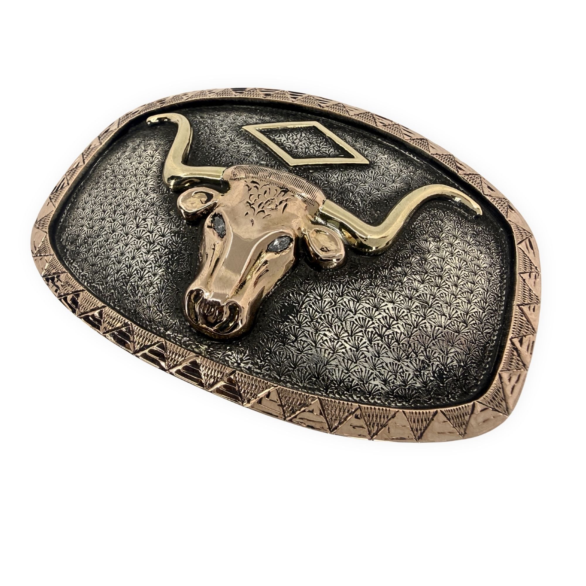 Belt buckle with longhorn bull design on a textured background