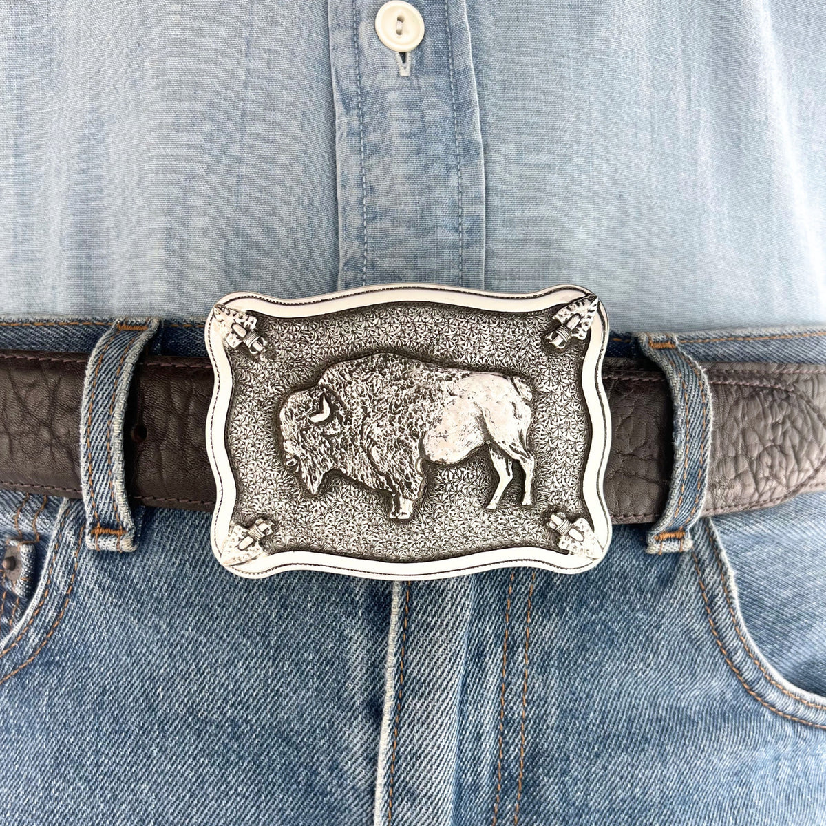 Bohlin 4 Point Buffalo sterling silver belt buckle worn at the waist, showing the buffalo centerpiece, arrowhead details, and engraved silver background.