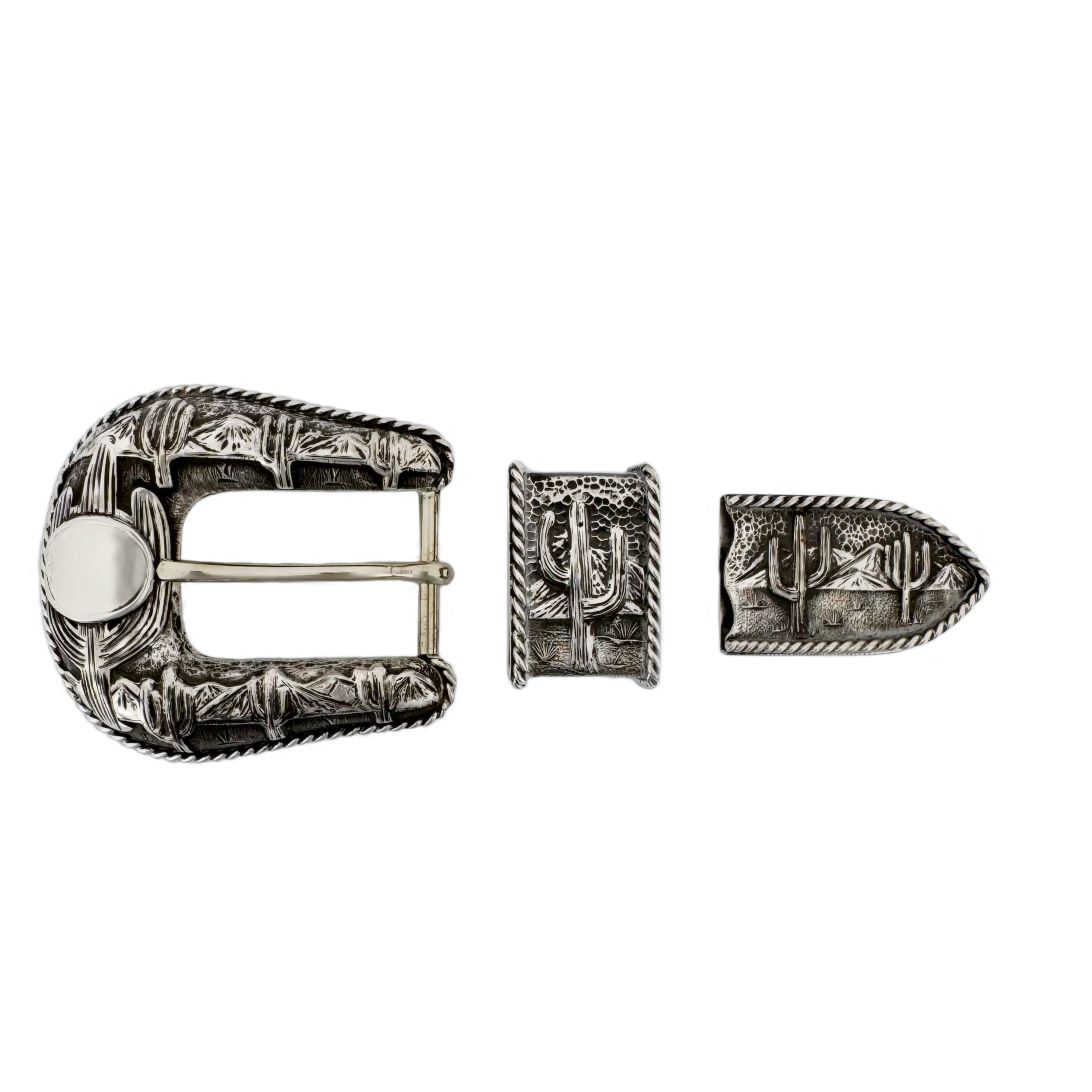 Silver belt buckle with cactus design on a white background