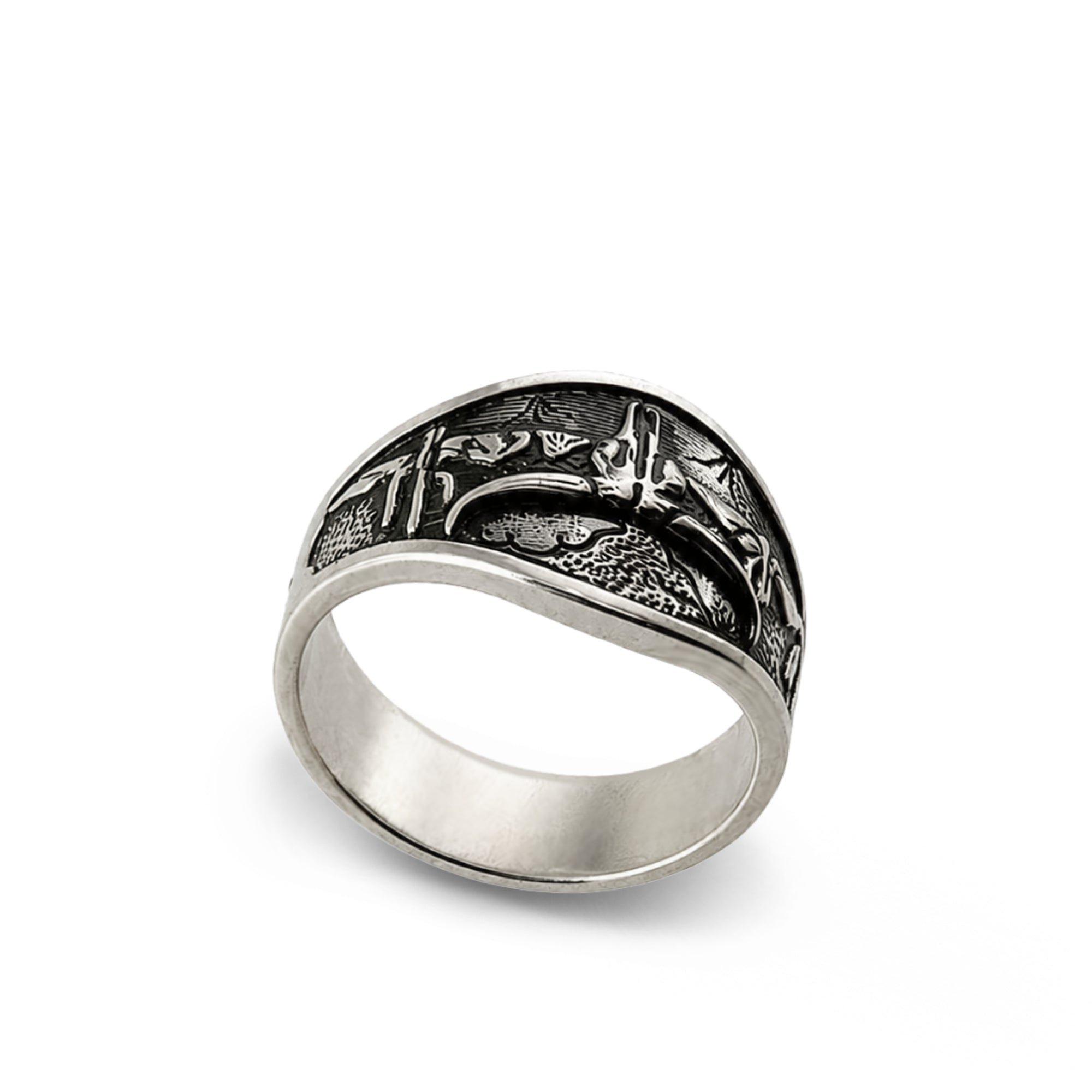 A silver-toned signet ring with a detailed, textured blackened top featuring a stylized design, shown on a plain white background.