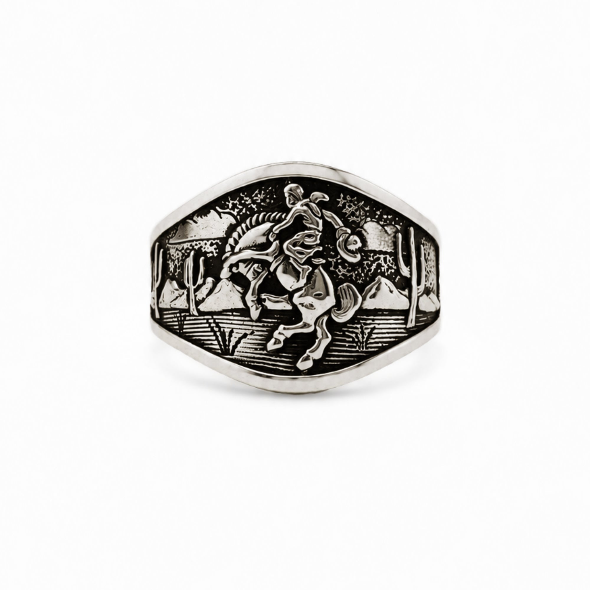 A silver signet ring featuring an engraved desert scene with a cowboy on a horse, set against a plain white background.