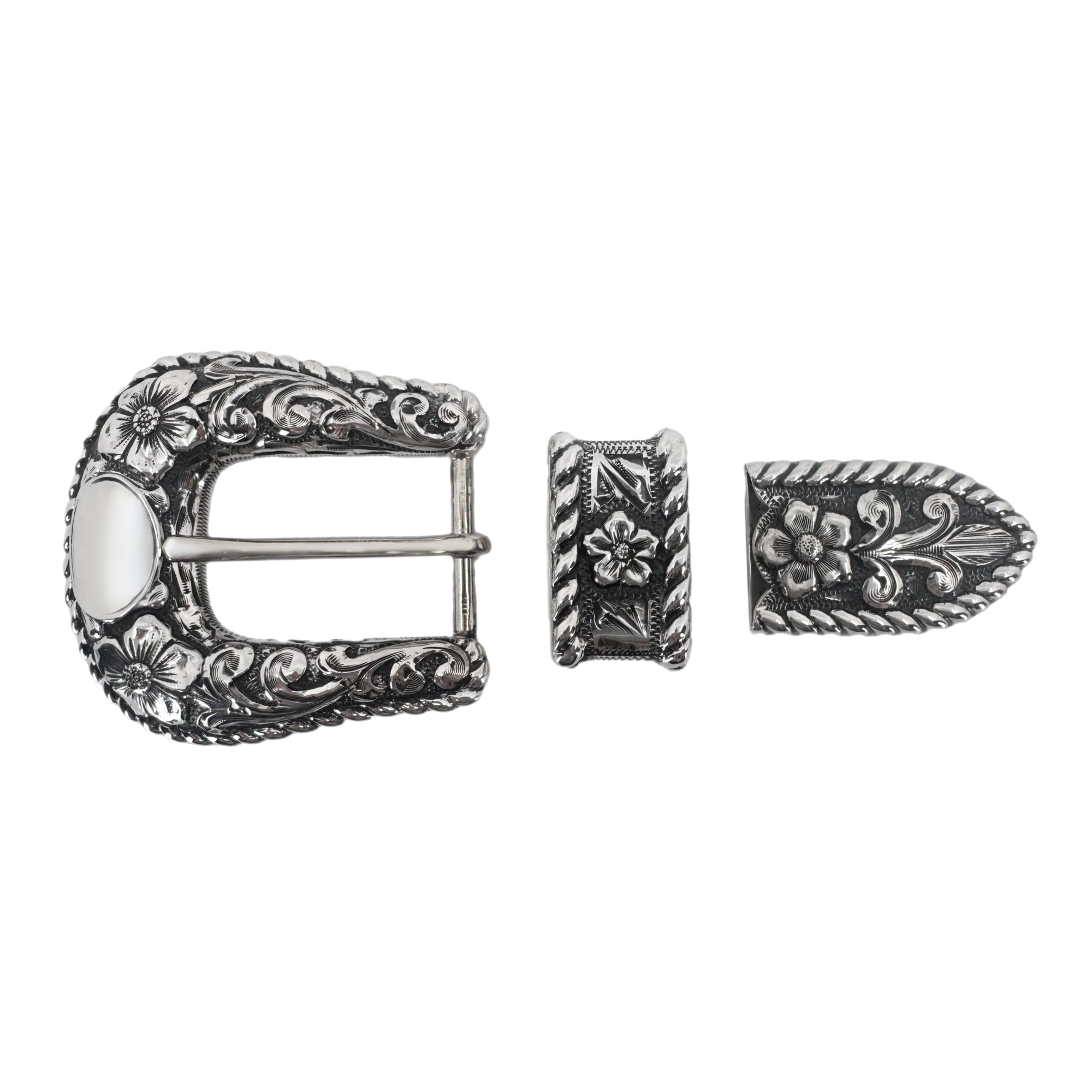 Overlaid flowers scrolls and a kick rope edge on a 3 piece all silver buckle set 