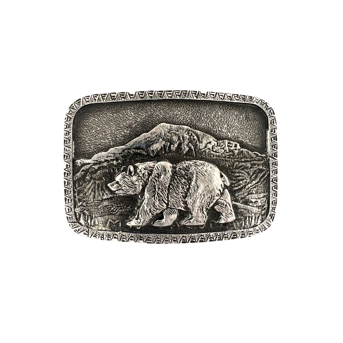 A rectangular silver-toned metal belt buckle featuring an embossed design of a bear walking in front of mountains, with a decorative border around the edge, shown on a plain white background.
