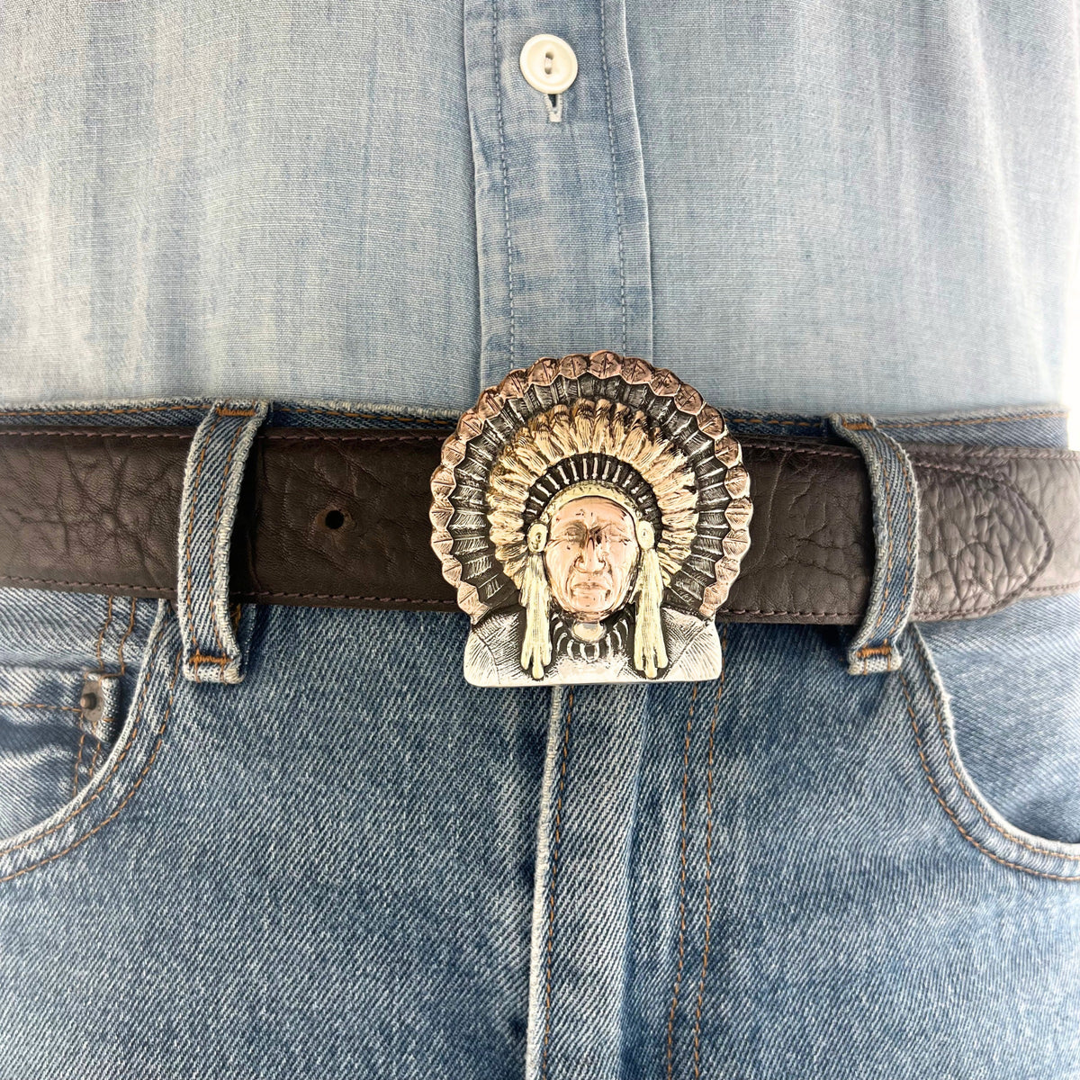 Bohlin The Chief three-color gold buckle displayed on a Western leather belt, featuring the historic Chief Red Wolf portrait and detailed gold headdress.